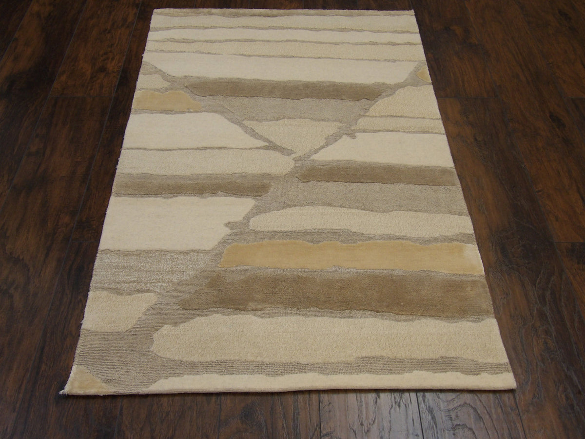 Close-up of wool-silk pile, gold and beige rug