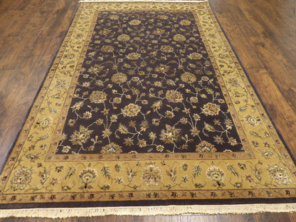 Close-up of wool-silk pile, gold and purple rug