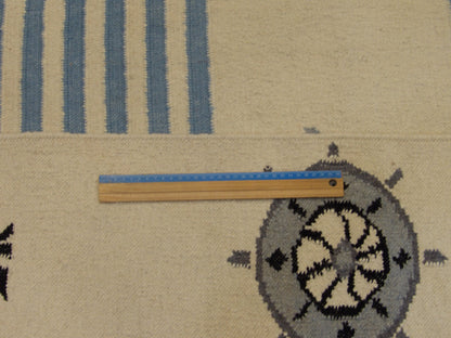 Full room view of coastal flat weave hand-knotted rug