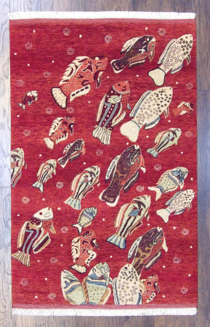 Fish design coastal hand-knotted wool rug in red, full view