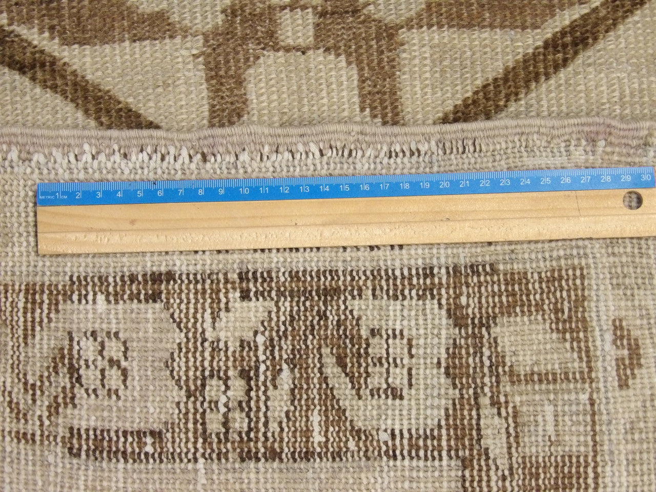 Brown and gray Oushak rug in room setting