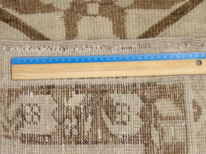 Brown and gray Oushak rug in room setting