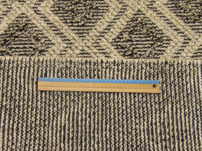 Black and beige geometric rug in room setting