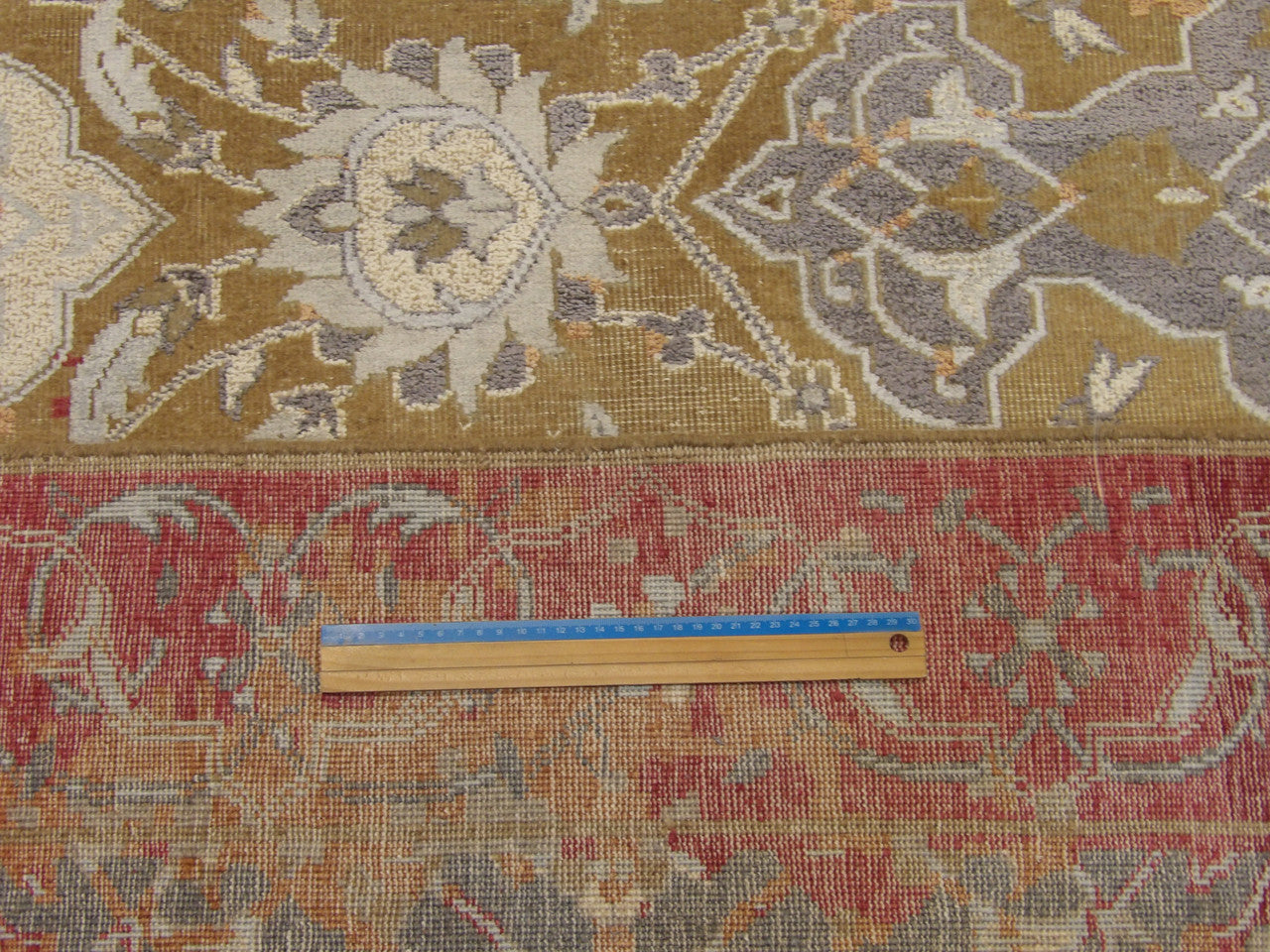 Gold and red vintage rug in room setting