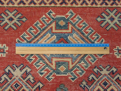 Beige and red Kazak rug in room setting