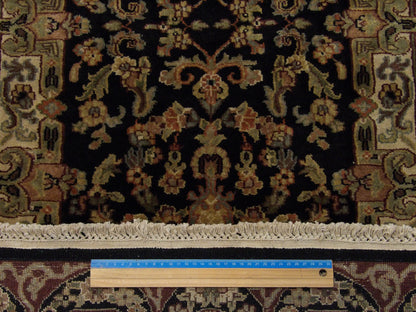 Black and red Tabriz runner in hallway setting