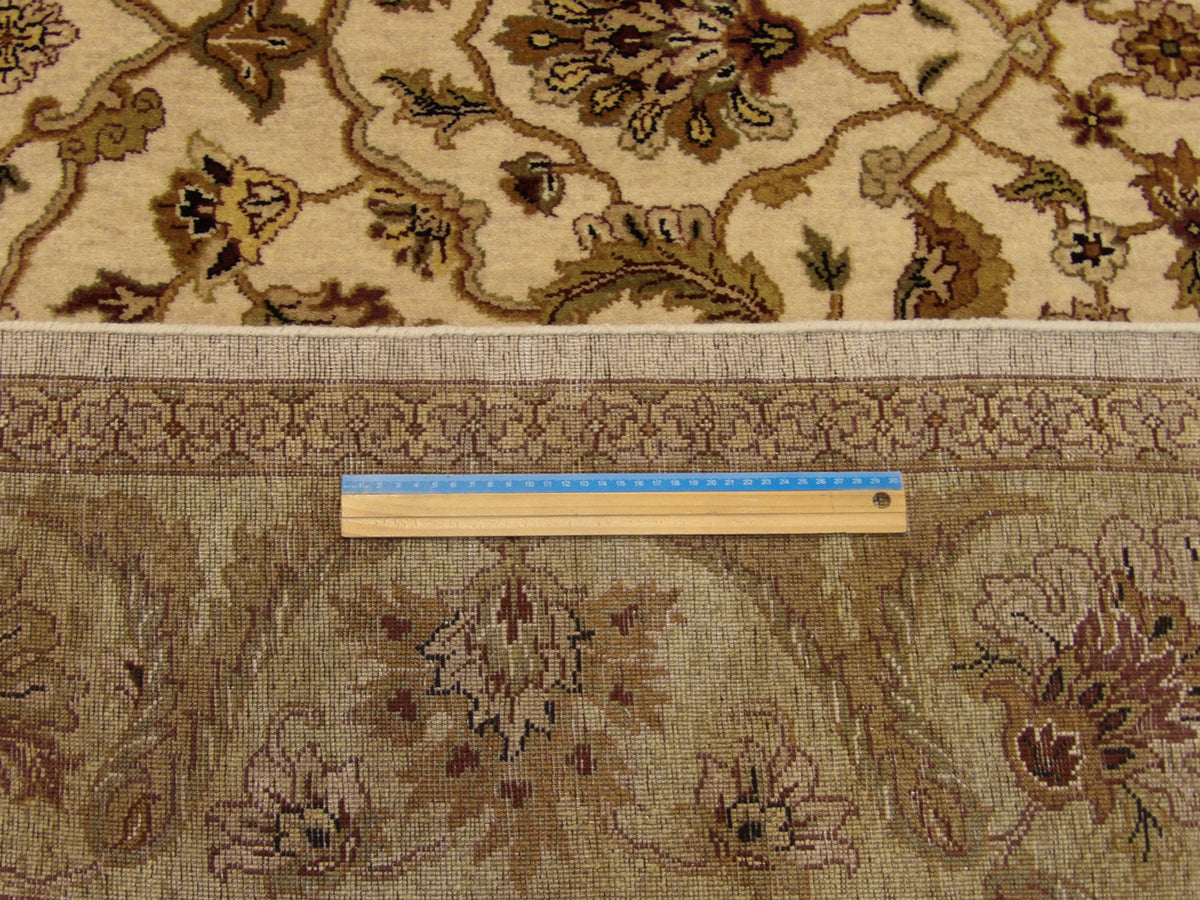 Green and beige Ziegler rug in room setting