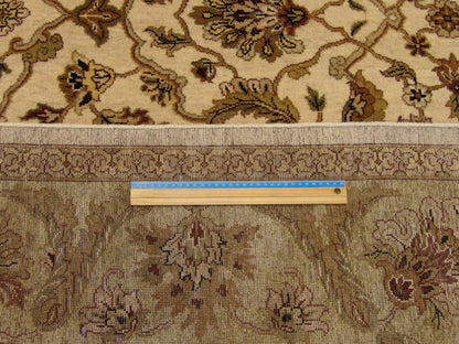 Green and beige Ziegler rug in room setting