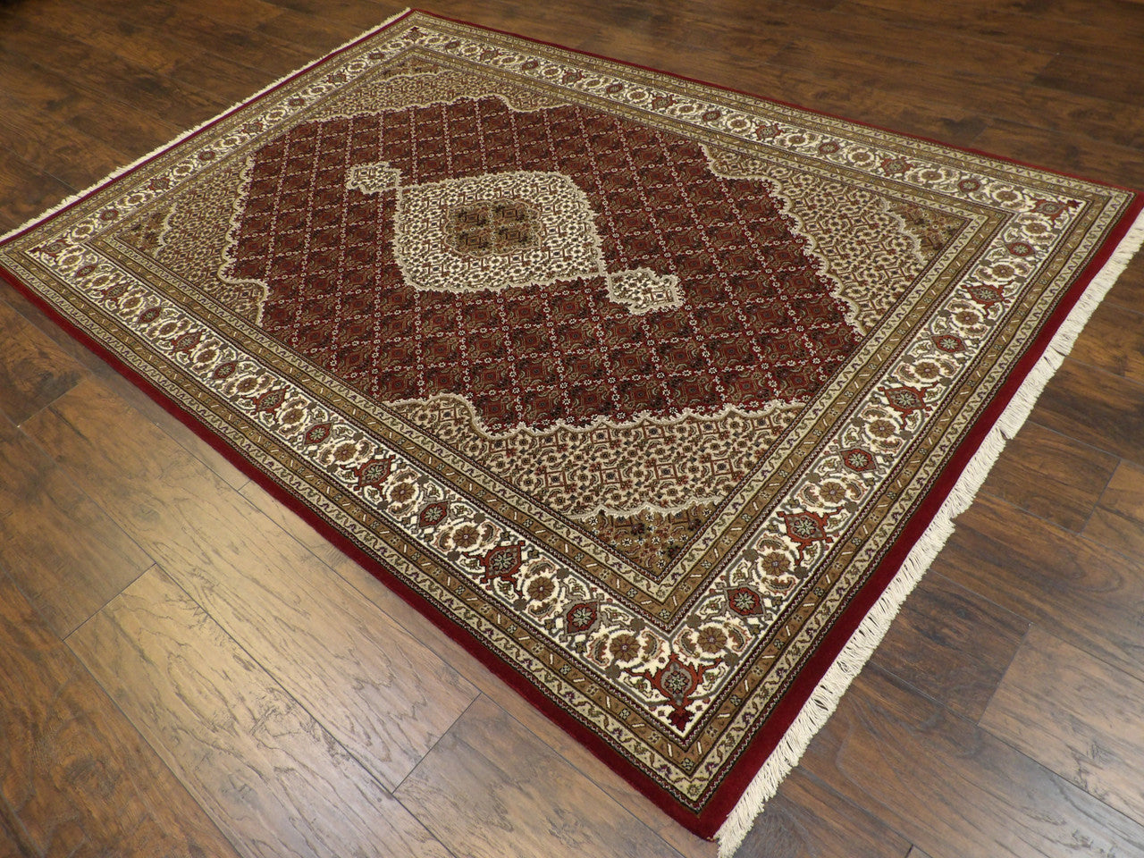 Red Persian Tabriz rug in a formal room setting