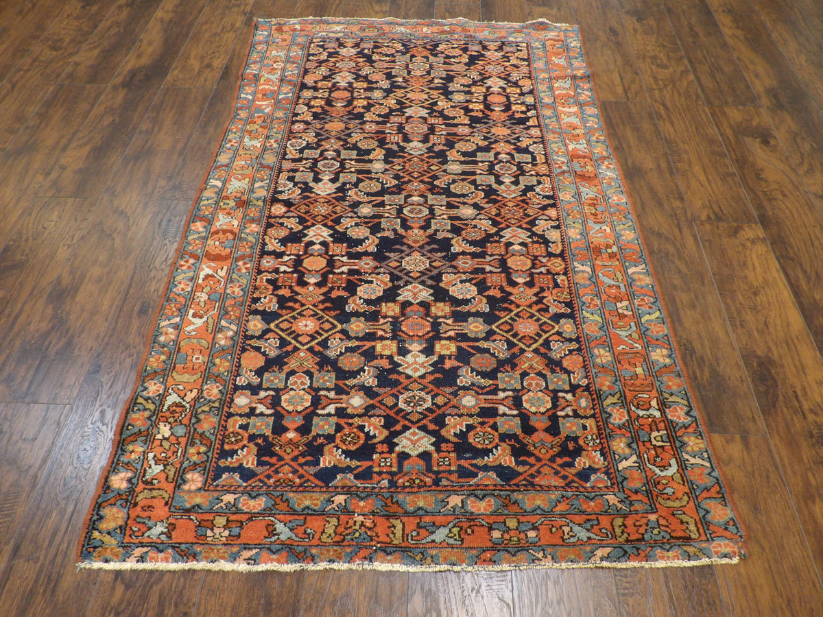 Close-up of wool pile, antique blue and rust rug
