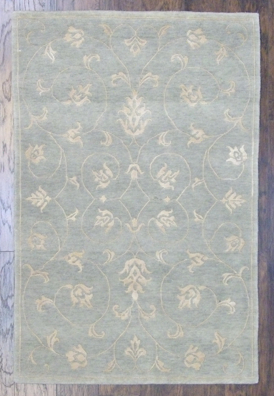 Transitional leaves design hand-knotted wool-silk rug in blue and gold, full view