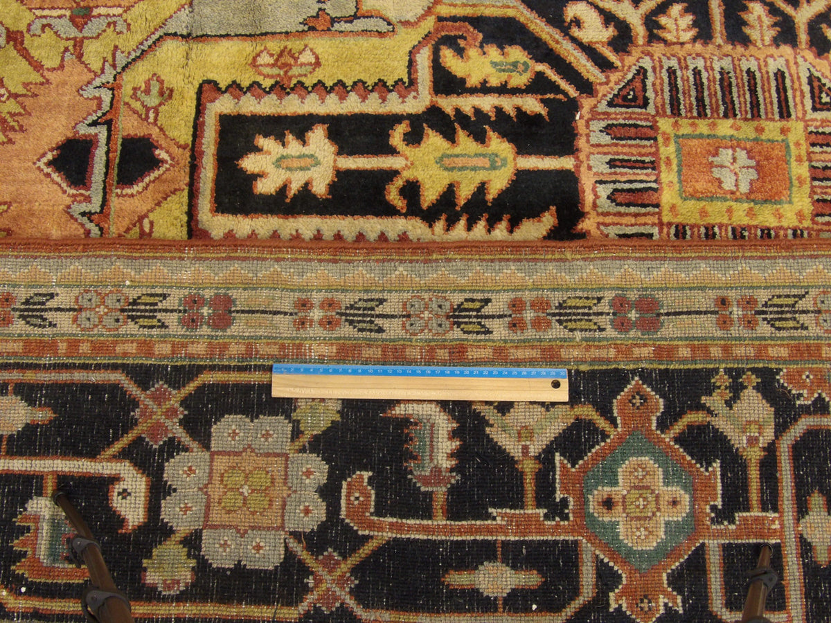 Full room view of oversized tribal Heriz hand-knotted rug