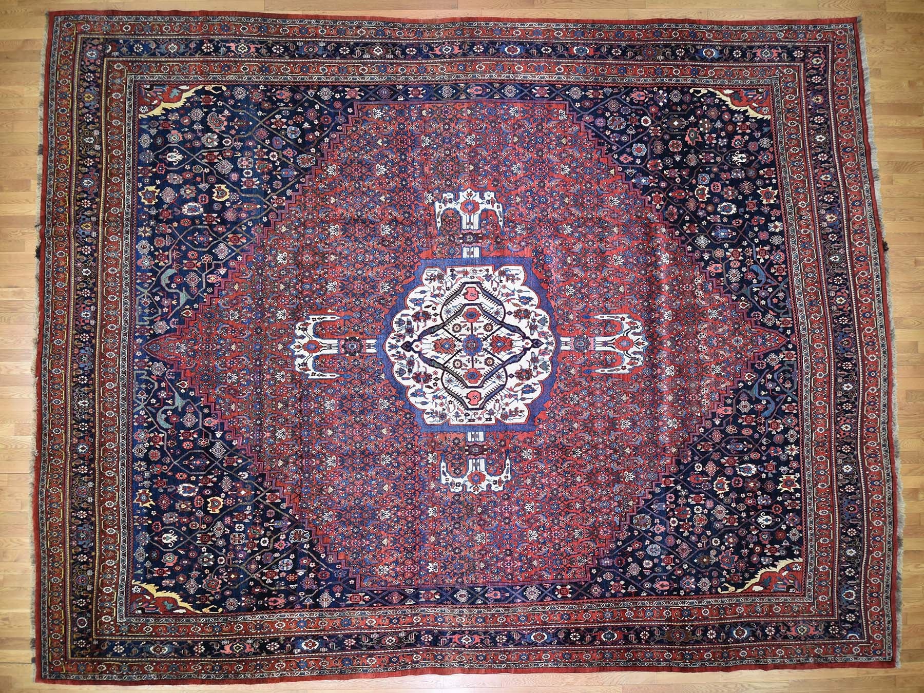 Antique hand-knotted wool rug in Red & Navy Blue, 14'6" x 19' — SKU O044876