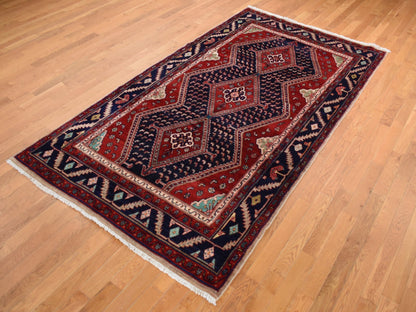 Persian hand-knotted wool rug in Red & Blue, 5'1" x 9'7" — SKU O087575 (view 3)